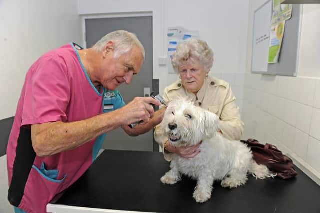 Vet Gordon Matthews with Doreen Rhodes and Mac, the West Highland Terrier.