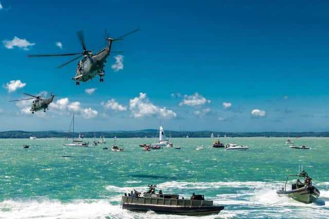 An image captures a mock assault off Southsea during the major D-Day 70 commemmorations in 2014. Picture: Lt Cdr 'Shamus' Roster photoboxgallery.com/roster
