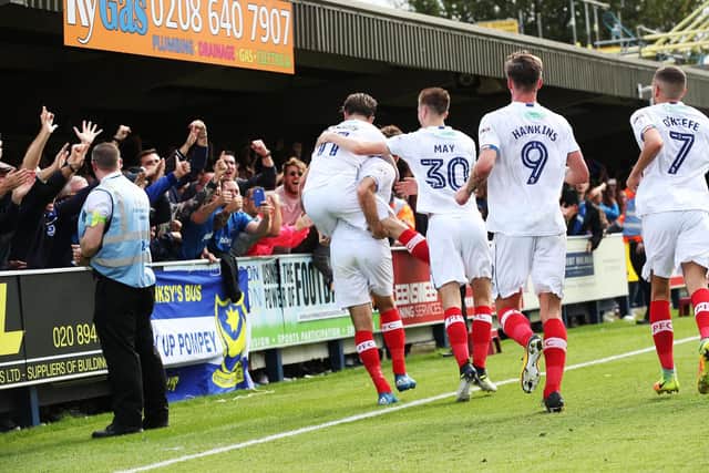 Pompey celebrate Brett Pitman's opening goal in their 2-0 win at AFC Wimbledon last season with the Fratton faithful. Picture: Joe Pepler