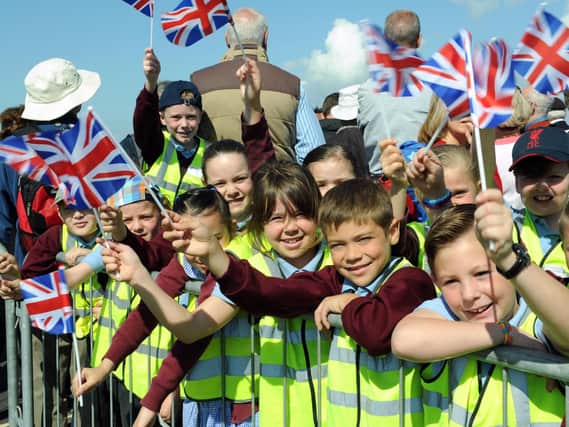 Children from Lyndhurst Junior School wave their flags at the D-Day 70 Drumhead service on Southsea Common in June, 2014