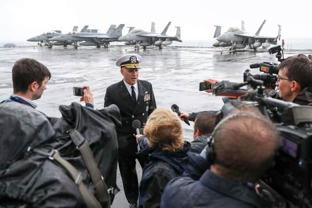 Rear Admiral Eugene H. 'Gene" Black, commander, Carrier Strike Group 8, talks to the media on the flight deck of the US Nimitz-class aircraft carrier USS Harry S. Truman, following its arrival into Stokes Bay. Photo: Andrew Matthews/PA Wire