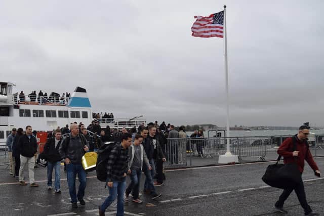 The first members of the ship's company arrive in Portsmouth after the arrival of USS Harry S Truman