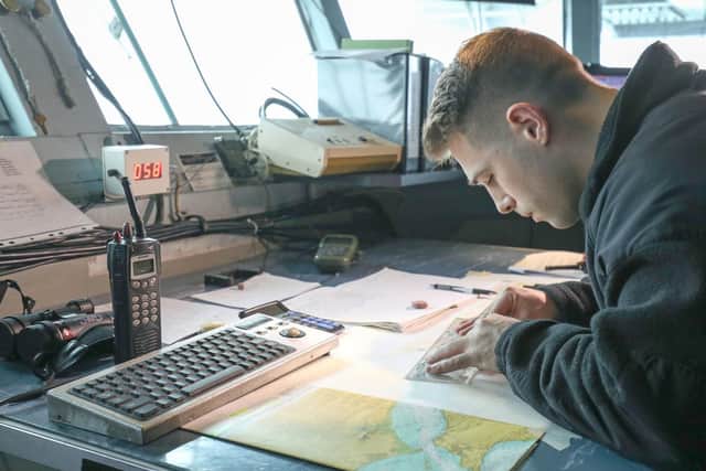 A member of the crew plots a course on the American aircraft carrier. Photo: Andrew Matthews/PA Wire