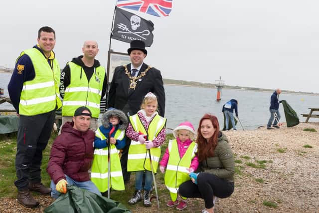 Cleaning up at the Eastney beach clean - standing, from left: Peter May of The Princess of Wales Royal Regiment; Sea Shepherd Phil Carpenter and The Lord Mayor of Portsmouth, cllr Lee Mason. Front, from left: the Davies family, Michael, Tristan (5yrs), Sommer (6yrs), Penelope (3yrs) and Emma     Picture: Duncan Shepherd
