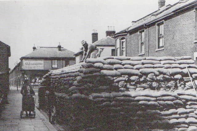 A sandbag-protected water tank, but in which street? I published this photograph five years ago without success. Does anyone recognise the location?