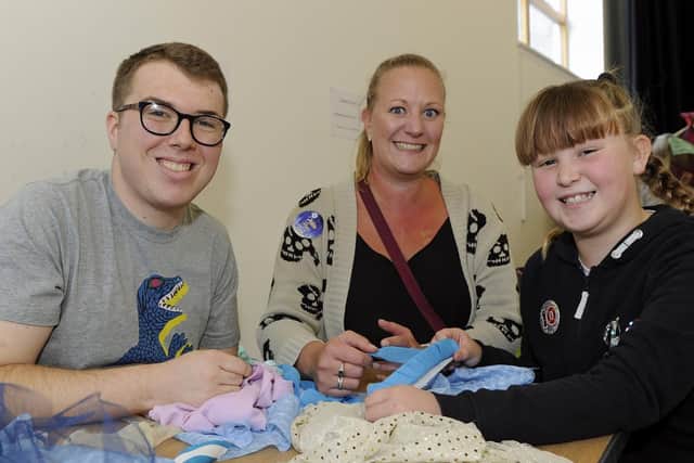 From left, Liam Davis works with mum Leanne Rogers and her daughter Betheny Rogers, 10. Picture: Ian Hargreaves
