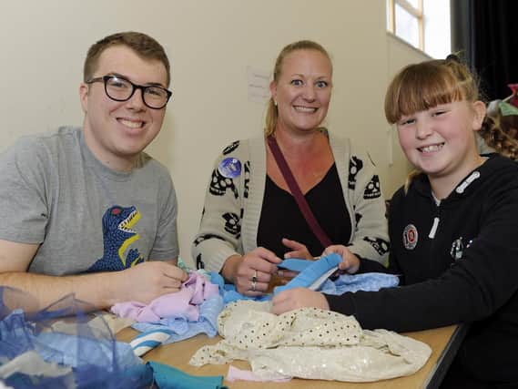 From left, Liam Davis works with mum Leanne Rogers and her daughter Betheny Rogers, 10. Picture: Ian Hargreaves