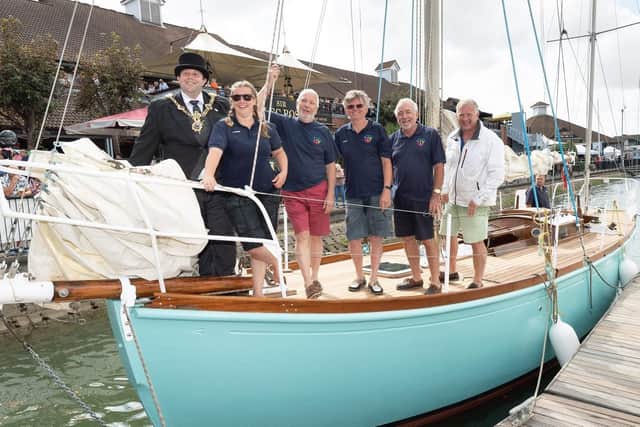Lively Lady after Around and Around volunteers returned her to Port Solent Marina in July, in a recreation of Sir Alec Rose's homecoming of 1968. Alan Priddy is pictured third-left. Picture: Keith Woodland
