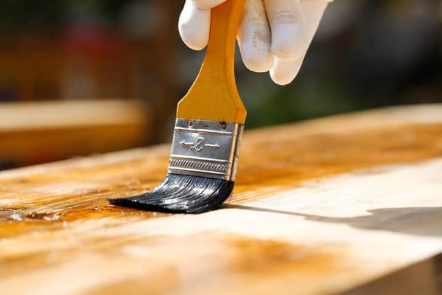 Garden furniture being treated with preservative.