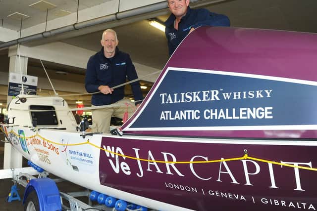 Andy Williams, left, and Nick Wright with the boat they will be on during the Talisker Whisky Atlantic Challenge in December