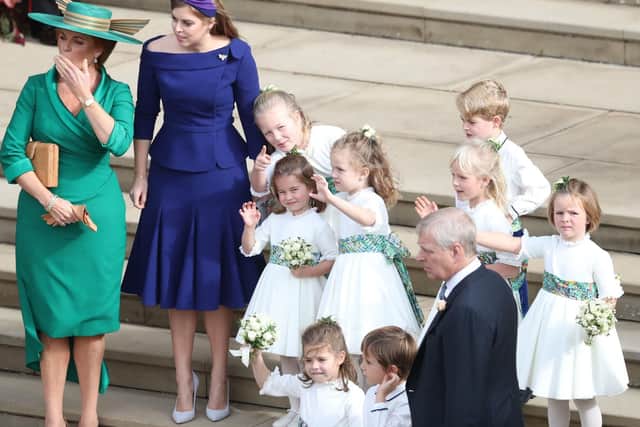 Sarah Ferguson, Princess Beatrice and the bridesmaids and page boys, including Princess Charlotte and Prince George wave off Princess Eugenie and her new husband Jack Brooksbank as they leave St George's Chapel in Windsor Castle following their wedding. Picture: Andrew Matthews/PA Wire