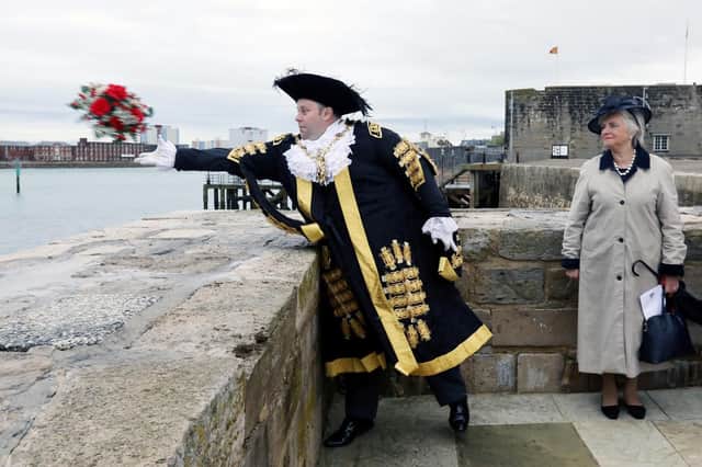 Lord Mayor of Portsmouth Cllr Lee Mason throws a wreath into the sea watched by deputy Lieutenant of Hampshire Joan Ferrer Picture: Chris Moorhouse