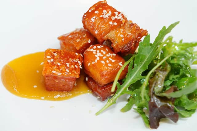 Sticky Asian pork belly bits with sesame sriracha and pineapple ketchup with salad. 
Picture: Sarah Standing (180639-2929)