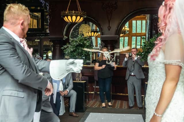 The owl flies, with the rings tied to its feet with ribbon, flies towards the best man Dave Cromey and the bride.