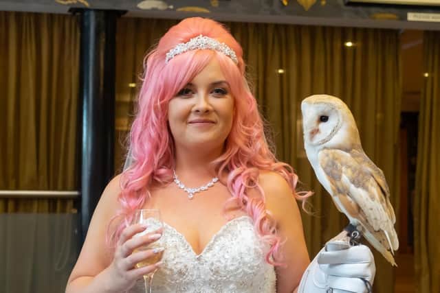 Amy holding the owl on her wedding day.