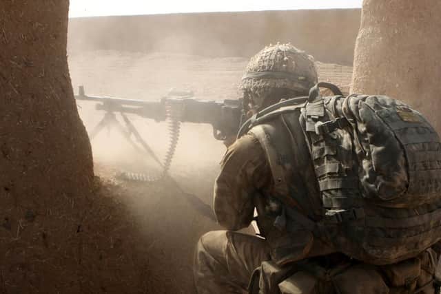 General Purpose Machine Gunner from B Company 3rd Battalion Parachute Regiment returns rounds at Taliban enemy positions during a advance to contact on Operation OQAB TSUKA