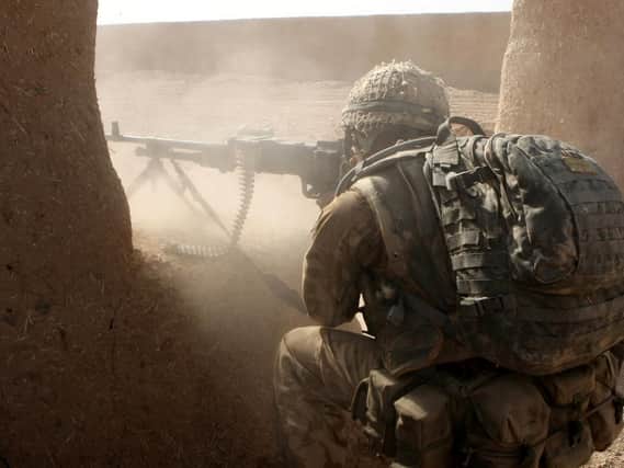 General Purpose Machine Gunner from B Company 3rd Battalion Parachute Regiment returns rounds at Taliban enemy positions during a advance to contact on Operation OQAB TSUKA