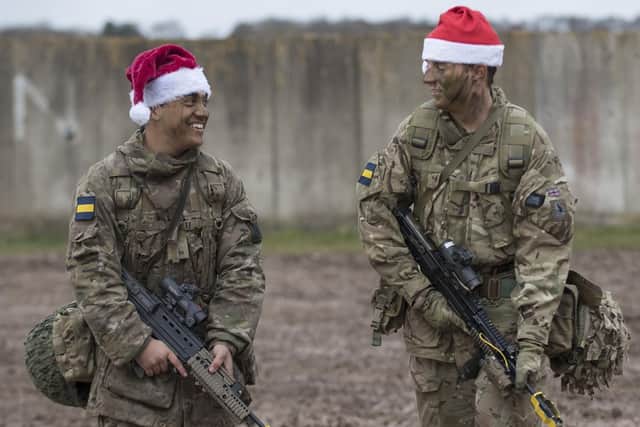 Soldiers from the Princess of Wales's Royal Regiment are urged to get into the festive spirit and join a special Christmas lunch. Pictured are Private Piers Smedley and Lance Corporal Paul Brien, soldiers of 4th & 3rd Battalion respectively, The Princess of Wales's Royal Regiment walking to the field kitchen to enjoy Christmas lunch after the conclusion of Exercise Snow Tiger on Copehill Down last year.