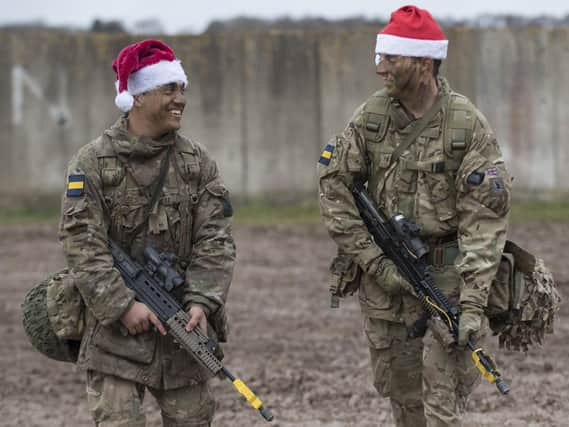 Soldiers from the Princess of Wales's Royal Regiment are urged to get into the festive spirit and join a special Christmas lunch. Pictured are Private Piers Smedley and Lance Corporal Paul Brien, soldiers of 4th & 3rd Battalion respectively, The Princess of Wales's Royal Regiment walking to the field kitchen to enjoy Christmas lunch after the conclusion of Exercise Snow Tiger on Copehill Down last year.