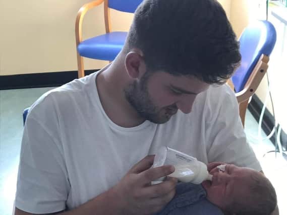 Jordan Osborne with his baby son, Jaxon
