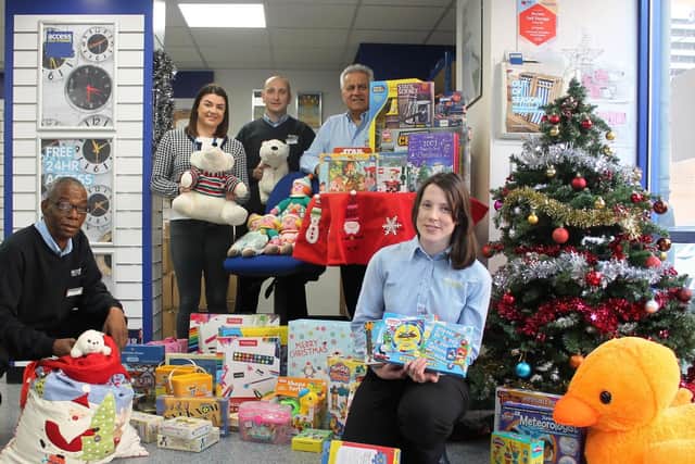 Some of the gifts collected in last years Access Self Storage Christmas charity appeal, pictured with charity workers and staff