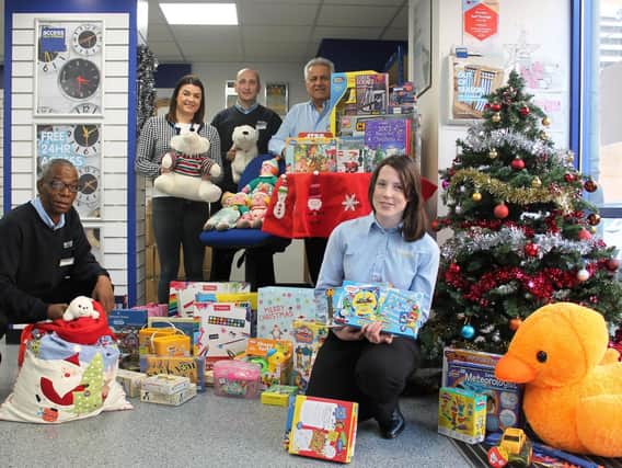Some of the gifts collected in last years Access Self Storage Christmas charity appeal, pictured with charity workers and staff