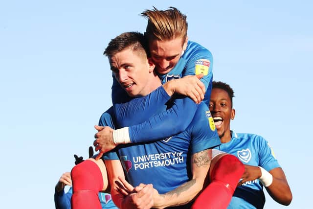 OlI Hawkins is congratulated for his opener by team-mate Ronan Curtis Picture: Joe Pepler
