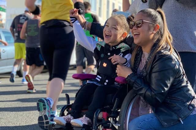 Malaya and her mum Kristine cheering on the runners