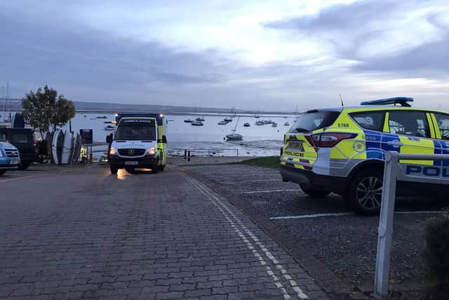 Police and paramedics attend the scene after a 25-year-old woman drove her Nissan Micra into water at a sailing club. Picture: Hillhead Coastguard/Solent News