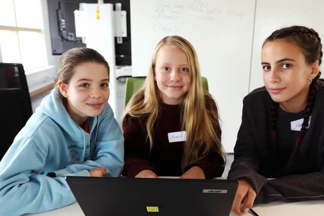 From left, Catrin Gibbard, 12, Amelia Phillips, 12, and Hannah Brook-Holmes, 13, at work on problem-solving at the CyberFirst Adventurers event