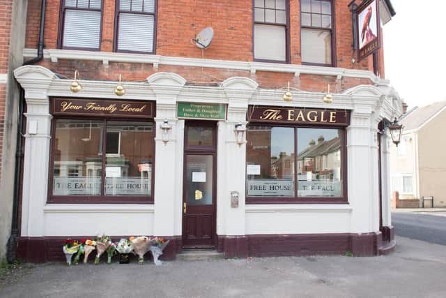 Floral tributes are left outside The Eagle public house in Elmhurst Road Gosport for David Hall Picture:Steve Reid