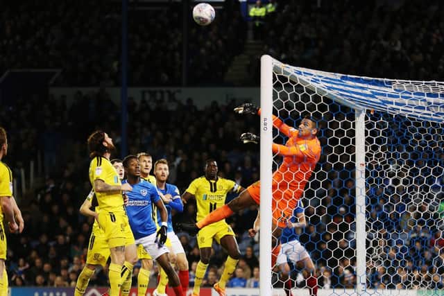 Burton keeper Dimitar Evtimov deals with a Pompey high ball into the box