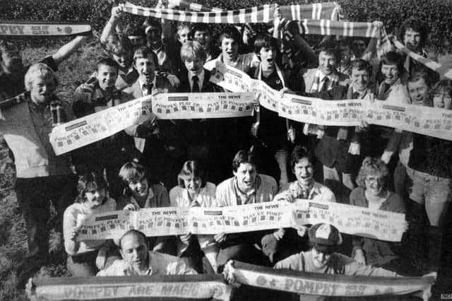 Proud Pompey fans in 1980, holding souvenir supplements of The News.