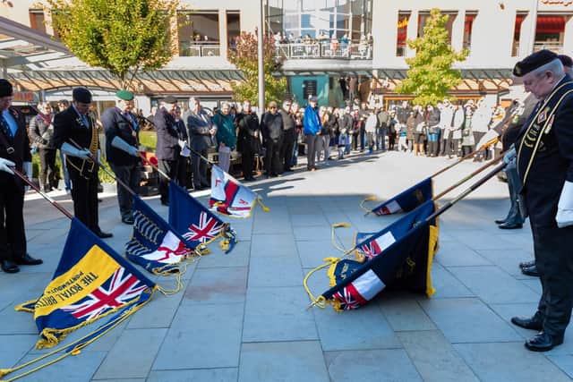 The standards are lowered to the sound of The Last Post. Picture: Vernon Nash