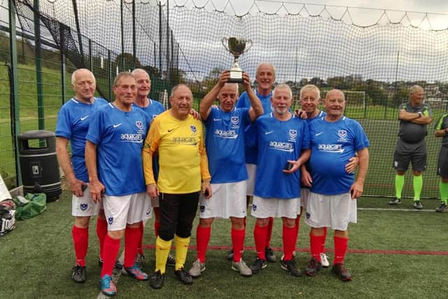 Pompey in the Community Walking Football team with their 70+ national champions trophy