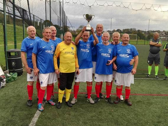 Pompey in the Community Walking Football team with their 70+ national champions trophy