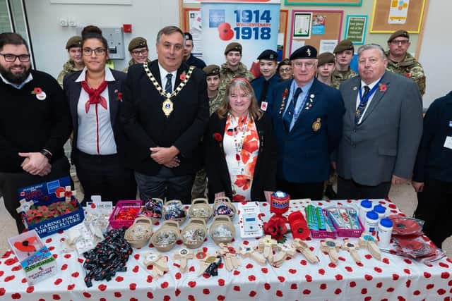 Launch of the Cosham Poppy Appeal at Tesco North Harbour - (Centre of the group left to right) Tesco duty manager Danielle Croker, Deputy Lord Mayor Cllr David Fuller, Cosham Poppy Appeal organisers Denise and Terry Bryant and Cllr Frank Jonas, with the police and army cadets. Picture: Vernon Nash (180680-008)