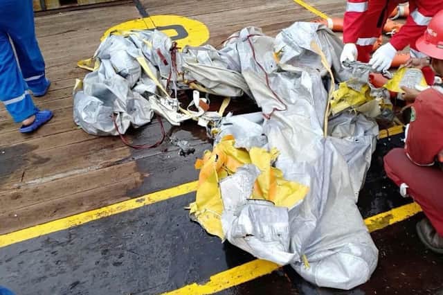 Rescuers inspect debris believed to be from Lion Air passenger jet that crashed. Picture: Indonesian Disaster Mitigation Agency (BNPB) / AP