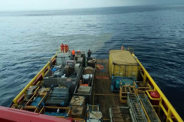 Rescuers inspect oi slick debris believed to be from Lion Air passenger jet that crashed. Picture: BNPB / AP