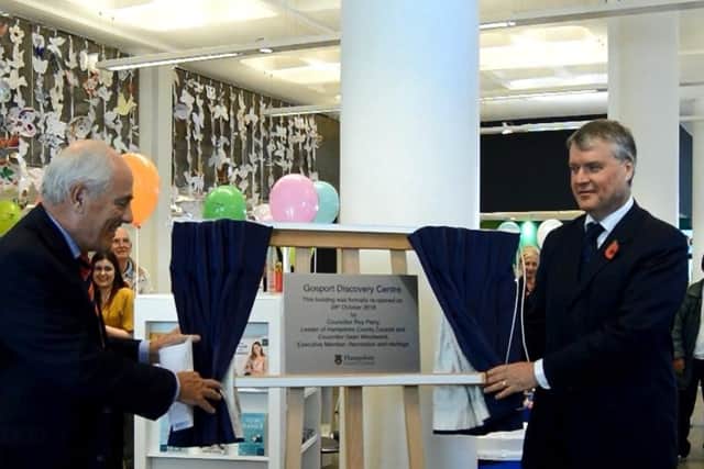 Cllr Roy Perry, left, and Cllr Sean Woodward, right, unveil the plaque for Gosport Discovery Centre. Picture: David George