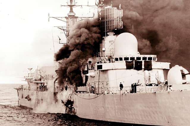 HMS Sheffield burns shortly after being hit by an Argentine Exocet missile, on 4/5/1982, whilst on radar picket duties off the coast of the Falkland Islands.