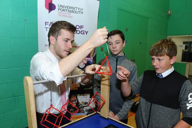 Left to right, Jake Harrold, a trainee teacher in computing doing a PGCE in the education and sociology department, who was helping the Faculty of Technology to promote STEM, with Harrison Davies, 13, and Joseph Mooney, 13. Picture: Sarah Standing (180806-7793)