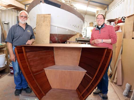 Boat-builder Derek Abra shows the altar he made in his workshop to the vicar of Hayling Island, the Rev Jenny Gaffin