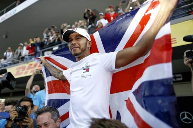 Up there with the greats - Lewis Hamilton celebrates his fifth F1 title.