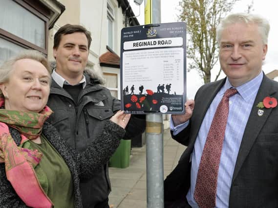 Gerald Vernon-Jackson attaches commemorative boards in Reginald Road, Eastney, to honour the city's fallen who died in WW1. Assisting him are D-Day collections researcher James Daly and Lindy Elliott of Portsmouth Library Archive