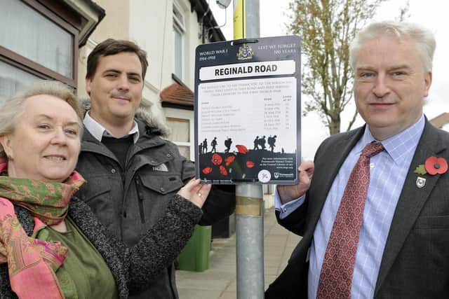 Gerald Vernon-Jackson attaches commemorative boards in Reginald Road, Eastney, to honour the city's fallen who died in WW1. Assisting him are D-Day collections researcher James Daly and Lindy Elliott of Portsmouth Library Archive