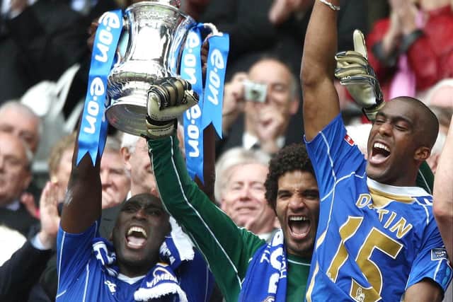 Portsmouth captain Sol Campbell with David James and Sylvain Distain lifts the FA Cup after beating Cardiff City 1-0 in the FA Cup Final at Wembley.