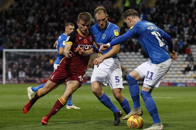 Bradford's George Miller and Pompey's Matt Clarke and Ronan Curtis. Picture: Daniel Chesterton/phcimages.com