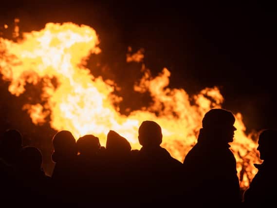People silhouetted by the bonfire at the Wickham Fireworks display.
Picture: Keith Woodland
