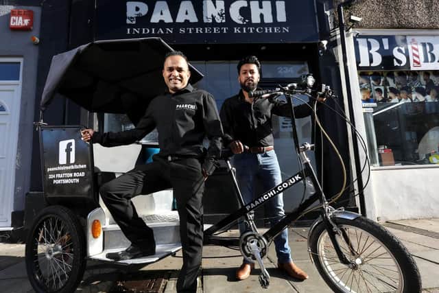 Operations manager Amirul Ali, left, and business owner Shahriar Uddin with their new rickshaw at Paanchi Indian Street Kitchen, Fratton Road. This replaces their last one which was stolen. Picture: Chris Moorhouse